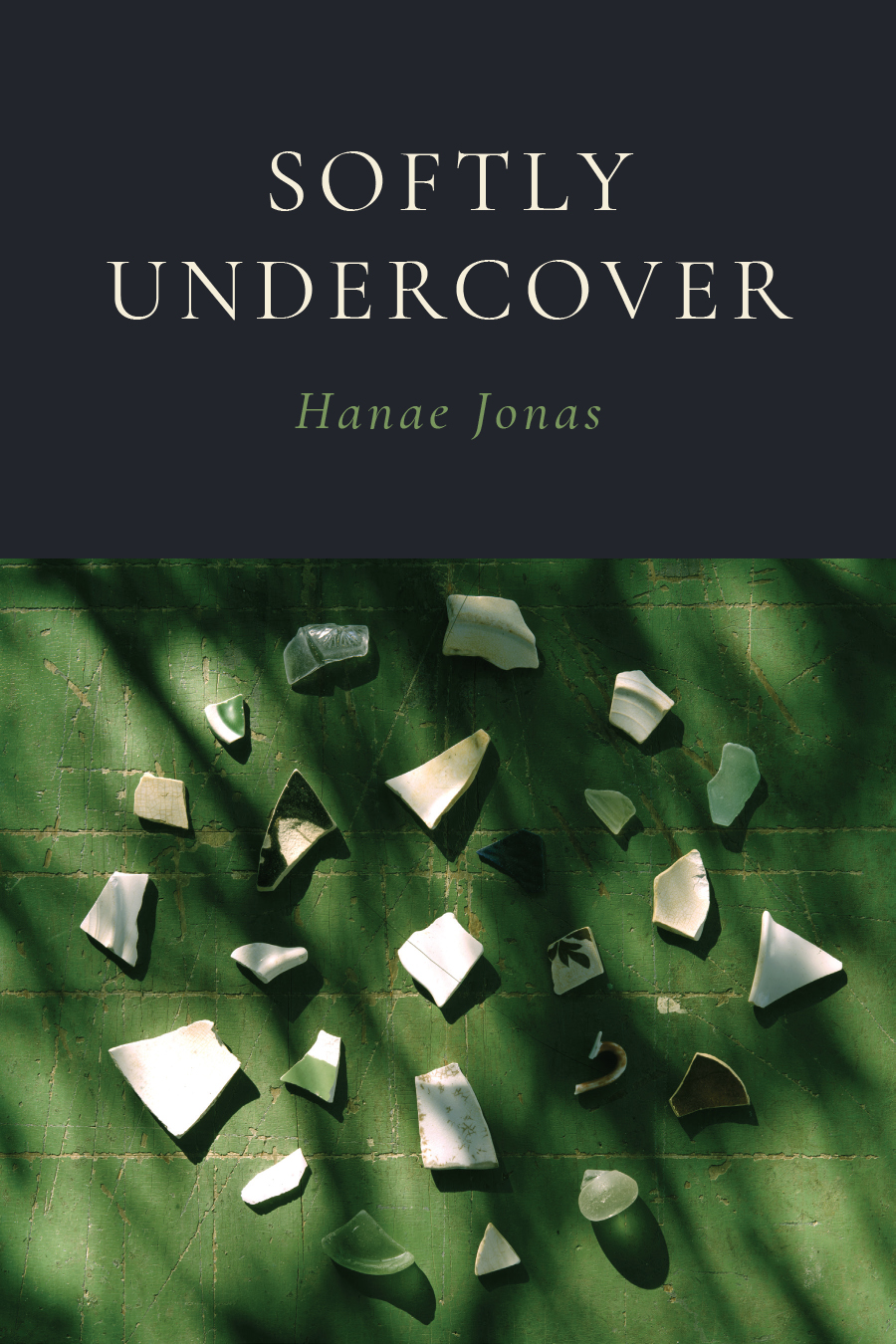 Front cover of Softly Undercover, by Hanae Jonas, featuring an image of light-colored pottery shards arranged in concentric circles on a green background with shadows.